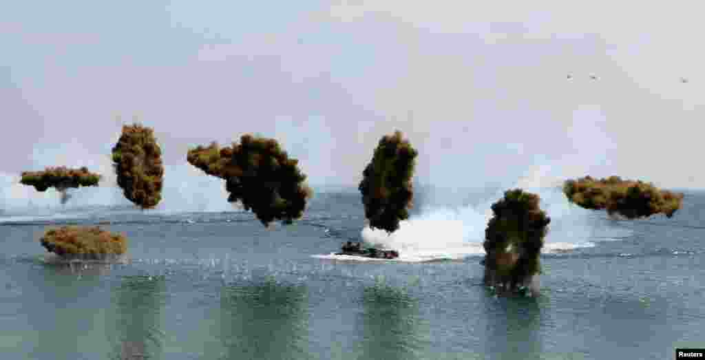 Amphibious assault vehicles of the South Korean Marine Corps throw smoke bombs during a U.S.-South Korea joint landing operation drill in Pohang, South Korea, April 26, 2013. The drill is part of the two countries' annual military training called Foal Eagle, which began on March 1 and runs until April 30.