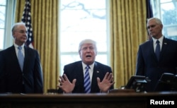 FILE - President Donald Trump reacts to the pulling of the American Health Care Act by congressional Republicans before a vote as he appears with Secretary of Health and Human Services Tom Price, left, and Vice President Mike Pence, right, in the Oval Office of the White House, March 24, 2017.