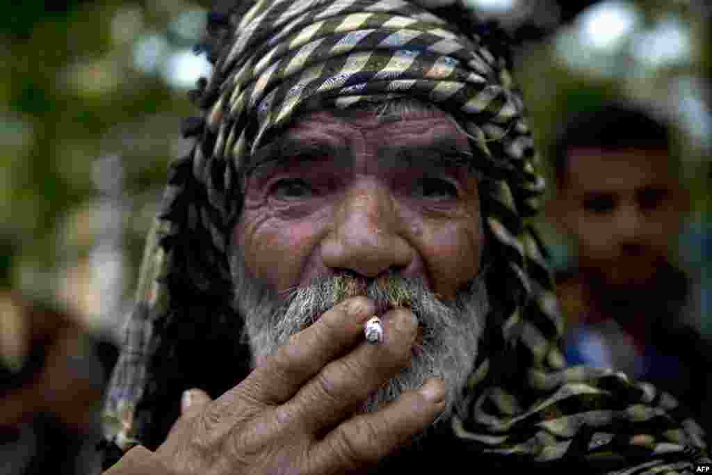 A Palestinian man smokes a cigarette in a demonstration in Gaza City in solidarity with Palestinian prisoners on hunger strike in Israeli jails.