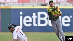 Cuban National baseball team shortstop Dainer Moreira(R) forcing out Dominican National baseball team outfielder Leury Garcia (1) at second base as the teams play in the Serie Del Caribe, in San Juan, Puerto Rico, Feb. 3, 2015. 