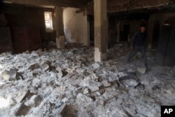 The remains of burned ancient books and manuscripts are seen inside Mosul's heavily damaged museum, March 8, 2017.