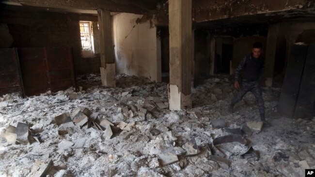 The remains of burned ancient books and manuscripts are seen inside Mosul's heavily damaged museum, March 8, 2017.