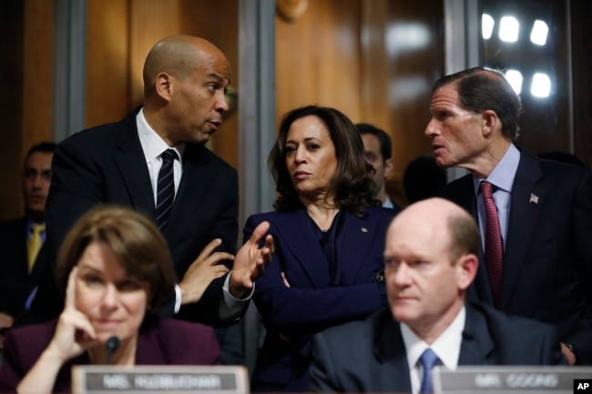 FILE - Senate Judiciary Committee members Sen. Cory Booker, D.-N.J., top left, Sen. Kamala Harris, D-Calif., and Sen Richard Blumenthal, D-Conn., right, talk as Sen. Jeff Flake, R-Ariz., discusses his concerns before the committee on Capitol Hill in Washi
