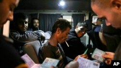 FILE - Israeli border police checks the ID's and work permits of Palestinian workers as they head back home to the West bank at the exit of the coastal city of Ashkelon, Israel, Nov. 11, 2014.