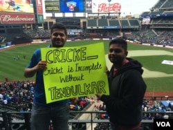 Cricket icon Sachin Tendulkar's fans hold a sign at Citi Field in New York before the start of an all-star contest featuring retired stars, Nov. 7, 2015.