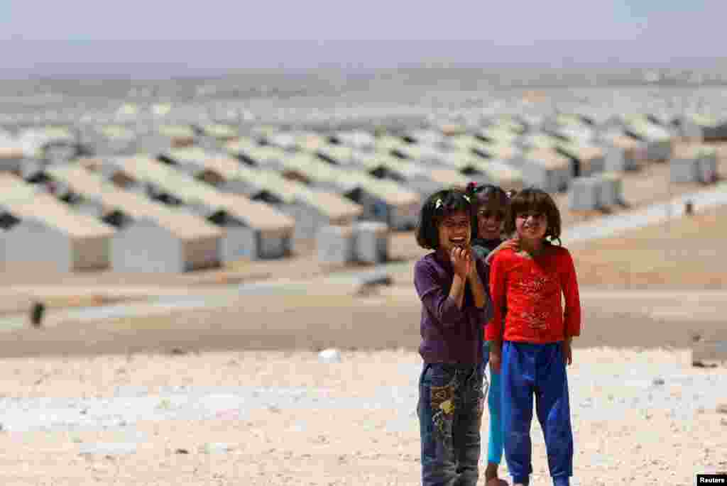 Syrian refugee children pose before a visit by actress Angelina Jolie, in her role as special envoy of the U.N. High Commissioner for Refugees (UNHCR), to Azraq refugee camp for Syrians displaced by conflict, near Al Azraq city, Jordan.