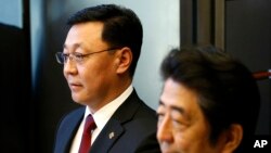FILE - Mongolian Prime Minister Jargaltulgyn Erdenebat, left, and his Japanese counterpart Shinzo Abe attend a joint press conference following their meeting at Abe's official residence in Tokyo, Oct. 14, 2016. 