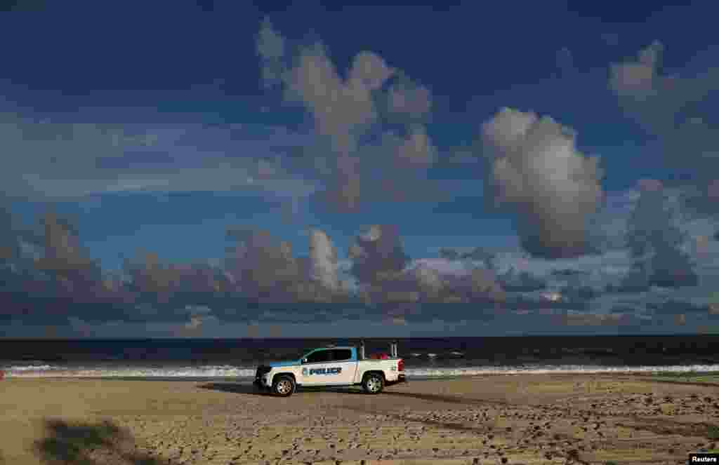 A police vehicle patrols the beach ahead of the arrival of Hurricane Florence in Myrtle Beach, South Carolina, Sept. 11, 2018. 
