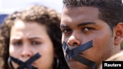 Members of the media tape their mouth as they protest against the arrest of journalists in Panama. (file)