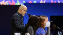 Italian Minister for Ecological Transition Roberto Cingolani speaks at the opening of a three-day Youth for Climate summit in Milan, Italy, Tuesday, Sept. 28, 2021. In the foreground are Ugandan climate activist Vanessa Nakate and Swedish climate activist