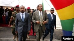 FILE - Eritrea's President Isaias Afwerki and Ethiopia's Prime Minister Abiy Ahmed arrive for an inauguration ceremony marking the reopening of the Eritrean embassy in Addis Ababa, Ethiopia, July 16, 2018. 