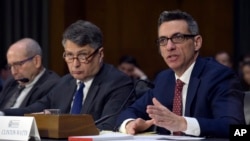 Clint Watts, right, a Senior Fellow at the Foreign Policy Research Institute Program on National Security, testifies before the Senate Intelligence Committee hearing on Capitol Hill in Washington, March 30, 2017, on Russian intelligence activities.