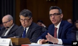 Clint Watts, right, a Senior Fellow at the Foreign Policy Research Institute Program on National Security, testifies before the Senate Intelligence Committee hearing on Capitol Hill in Washington, March 30, 2017, on Russian intelligence activities.