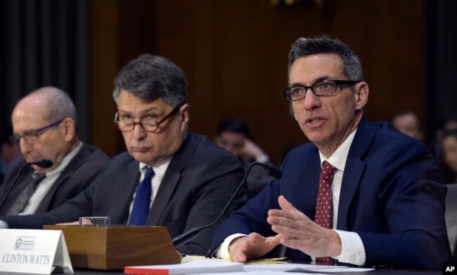 Clint Watts, right, a Senior Fellow at the Foreign Policy Research Institute Program on National Security, testifies before the Senate Intelligence Committee hearing on Capitol Hill in Washington, March 30, 2017, on Russian intelligence activities.