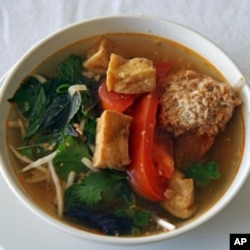 Linh Nguyen’s Vietnamese soup features fried tofu, tomatoes, a scattering of fresh herbs and some delicate poached crab and pork dumplings.