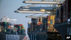 FILE - Container ships are seen at the Port of Savannah, Georgia, Sept. 29, 2021. A World Trade Organization arbitrator has decided that China can impose tariffs on imports from the U.S. totaling up to $645 million a year, capping a decade-long dispute.