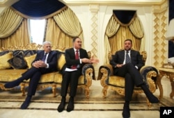 From left, Atheel al-Nujaifi, former governor of Ninevah province; Rafia Hiyad al-Issawi, former Iraqi Finance Minister; and Sheikh Khamis al-Khanjarin, an Iraqi businessman, talk with the Associated Press on Dec. 1, 2015, at a private villa in Dubai, United Arab Emirates.