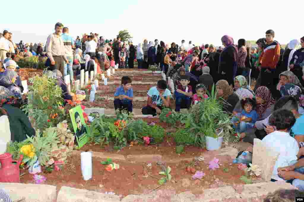 Displaced Afrin people visit the graves of their beloved ones in the eid