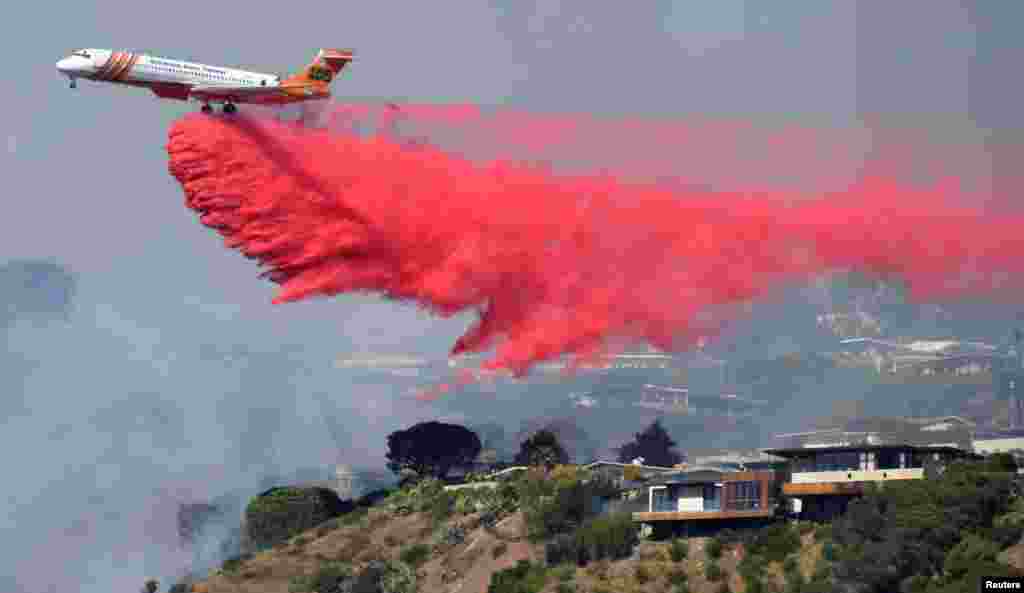 Firefighters battle a fire from the air. The blaze was threatening homes in the Pacific Palisades community of Los Angeles, California, Oct. 21, 2019.