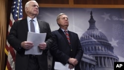 FILE - Sen. John McCain, R-Ariz., (left) and Sen. Lindsey Graham, R-S.C., wait to speak during a news conference on Capitol Hill in Washington, Jan. 21, 2016.