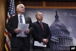 FILE - Sen. John McCain, R-Ariz., (left) and Sen. Lindsey Graham, R-S.C., wait to speak during a news conference on Capitol Hill in Washington, Jan. 21, 2016.