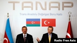 FILE - Turkey's Prime Minister Recep Tayyip Erdogan, right, and Azerbaijan's President Ilham Aliyev hold a news conference following a signing ceremony in Istanbul, June 26, 2012. 