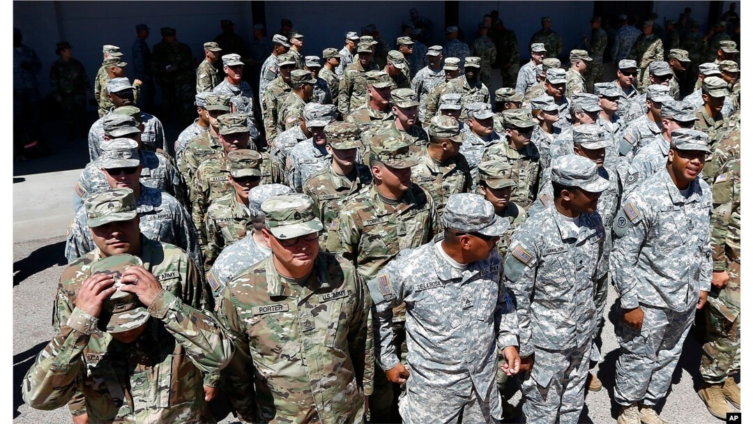 Arizona National Guard soldiers line up as they get ready for a visit from Arizona Gov. Doug Ducey prior their deployment to the Mexico border at the Papago Park Military Reservation, April 9, 2018, in Phoenix.