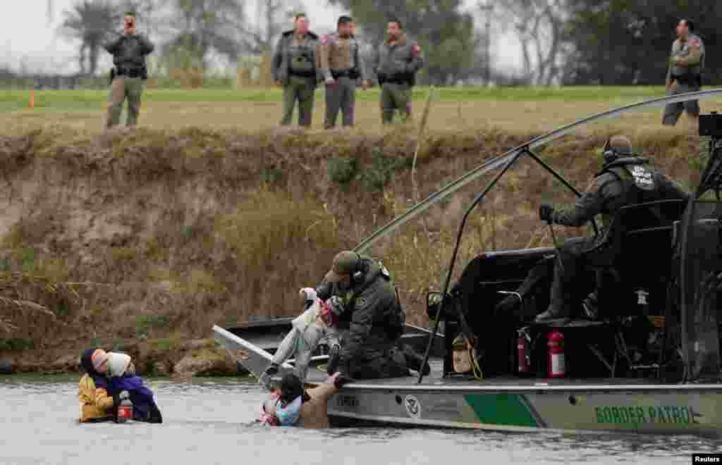 A U.S. border patrol boat rescues migrants crossing the Rio Bravo towards the United States, seen from Piedras Negras, Mexico, Feb. 10, 2019.