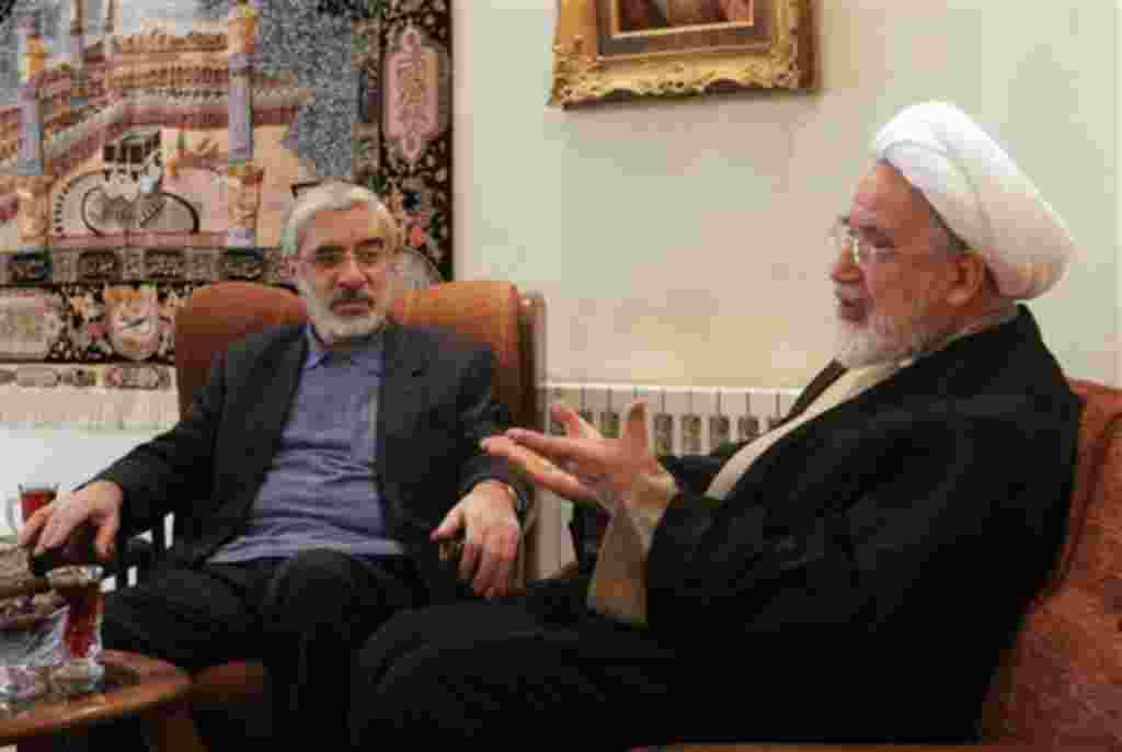 In this Saturday, Oct. 10, 2009 photo, leaders of Iranian opposition, Mahdi Karroubi, right, and Mir Hossein Mousavi talk in Tehran, Iran. The showdown between Iran's clerical leaders and a resilient protest movement sharpened Saturday Nov. 14, 2009, as 