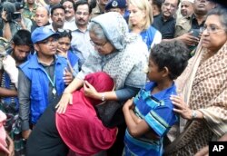 Bangladeshi Prime Minister Sheikh Hasina, center, meets with Rohingya Muslims at Kutupalong refugee camp, near the border town of Ukhia, Bangladesh, Sept. 12, 2017.