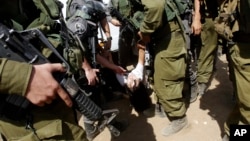Israeli soldiers remove French diplomat Marion Castaing from her truck containing emergency aid, West Bank herding community of Khirbet al-Makhul, Sept. 20, 2013.