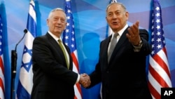 Israel's Prime Minister Benjamin Netanyahu , right, welcomes U.S. Defense Secretary James Mattis in his offices in Jerusalem, April 21, 2017.