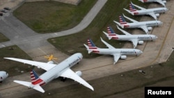 FILE PHOTO: American Airlines passenger planes (L) parked due to flight reductions made to slow the spread of coronavirus disease (COVID-19), at Tulsa International Airport in Tulsa, Oklahoma, U.S. March 23, 2020. The planes on the right are 737 MAX, park