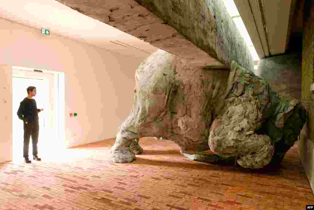 A member of the staff looks at one of the items in Adrian Villar Rojas&#39; &quot;Today We Reboot The Planet&quot; exhibition at the Serpentine Sackler Gallery of the Serpentine Sackler Gallery in London.&nbsp;