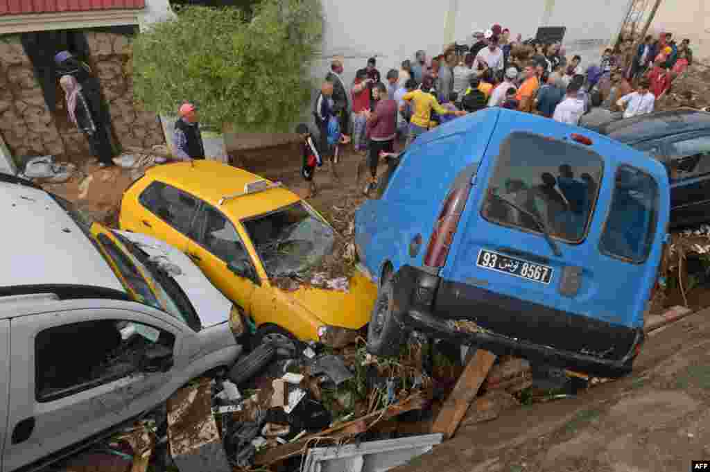 Cars are piled up in a street after being swept away by torrential rains in the city of Mhamdia near the Tunisian capital Tunis.