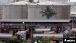 FILE - Petrol tankers load fuel from a depot in Lagos, Nigeria, Jan. 29, 2006. Military offensives in Lagos and Ogun states have left more than 100 militants dead, one official says.