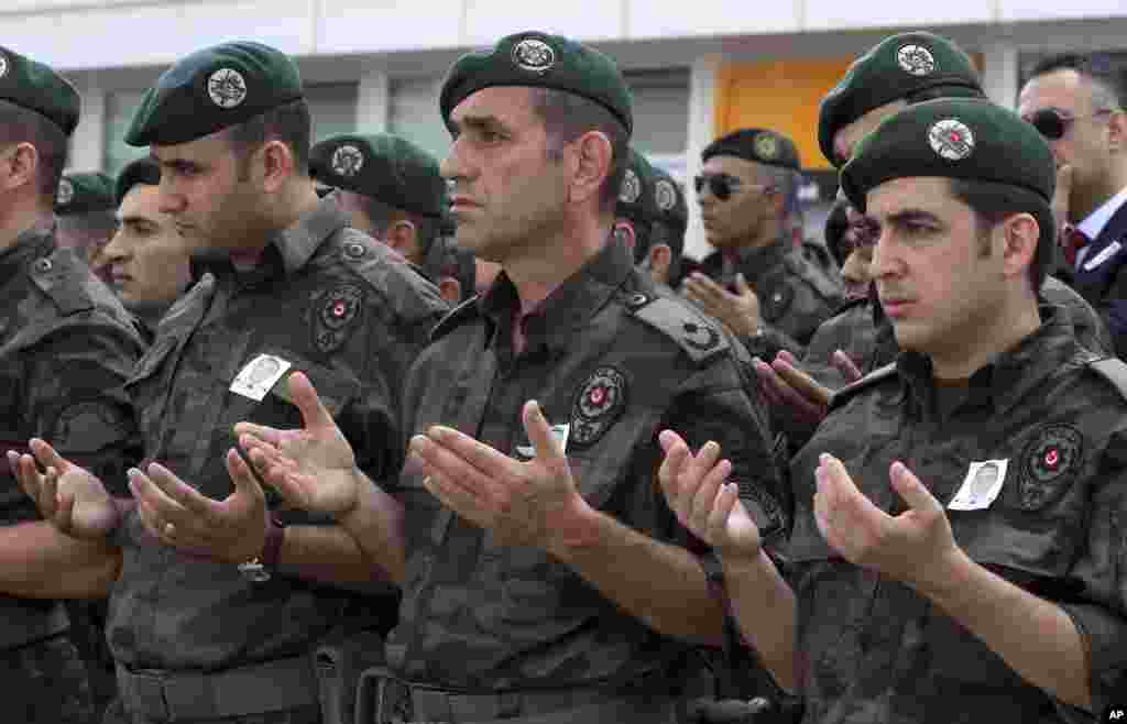 Turkish police officers pray during a ceremony at the police headquarters in Ankara for special operations officer Sahin Polat Aydin, one of the four officers killed Monday in a landmine attack attributed to militants of the Kurdistan Workers&#39; Party, or PKK, in Silopi, southeastern Turkey, Aug. 11, 2015.