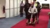 Bobi Wine is seen in a wheelchair just before his departure at Entebbe International Airport, in Entebbe, Uganda, Aug. 31, 2018 in this still image taken from a social media video on September 1, 2018. 
