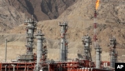 In this Jan. 22, 2014 photo, a gas flare burns in a gas refinery in South Pars gas field, on the northern coast of the Persian Gulf, in Asalouyeh, Iran.