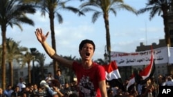 Protesters chant slogans as they march following an attack by security forces in Tahrir Square, in Cairo, Egypt, Saturday, April 9, 2011