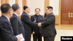 North Korean leader Kim Jong Un meets members of the high-level delegation of the Democratic People's Republic of Korea, which visited South Korea to attend the opening ceremony of the 23rd Winter Olympics.