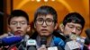 Pro-democracy activist Alex Chow, center, speaks to reporters outside the Court of Final Appeal in Hong Kong, Feb. 6, 2018. 