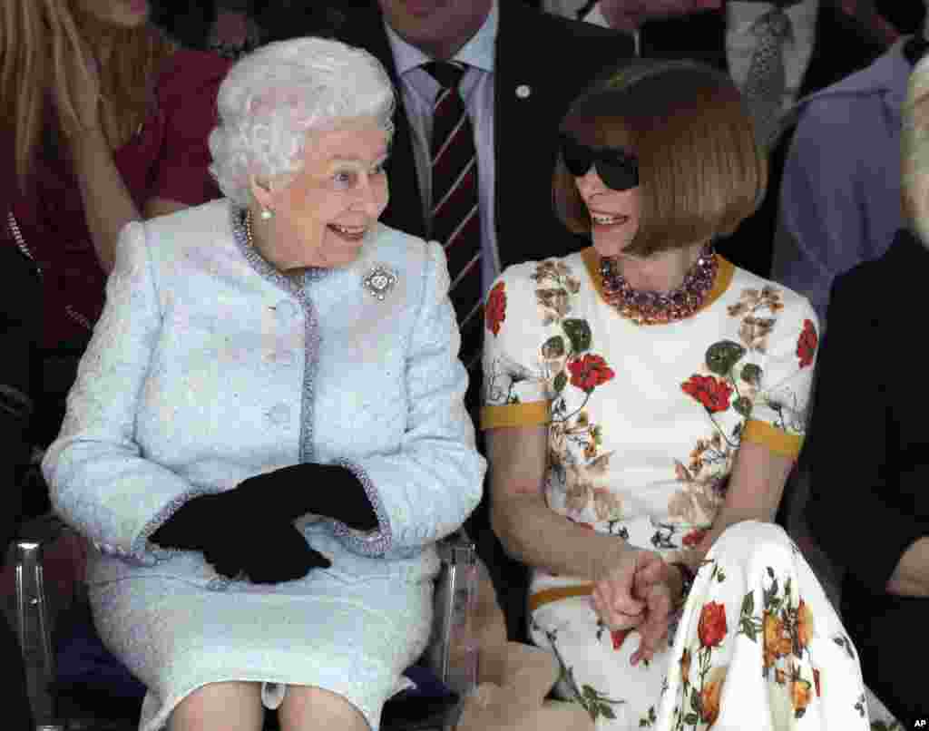 Britain&#39;s Queen Elizabeth sits next to fashion editor Anna Wintour as they view Richard Quinn&#39;s runway show before presenting him with the inaugural Queen Elizabeth II Award for British Design, during her visit to London Fashion Week&#39;s BFC Show Space in central London.