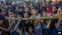 Rohingya Muslim children, who crossed over from Myanmar into Bangladesh, wait to receive aid during a distribution near Balukhali refugee camp, Bangladesh, Sept. 25, 2017.