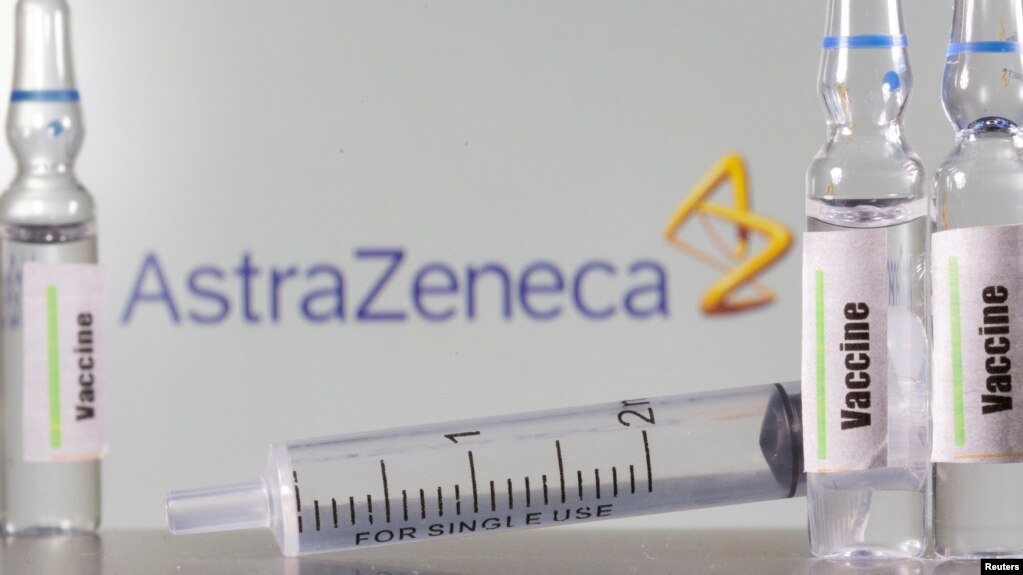 FILE PHOTO: A test tube labelled with the word Vaccine is seen in front of AstraZeneca logo in this illustration taken, September 9, 2020.