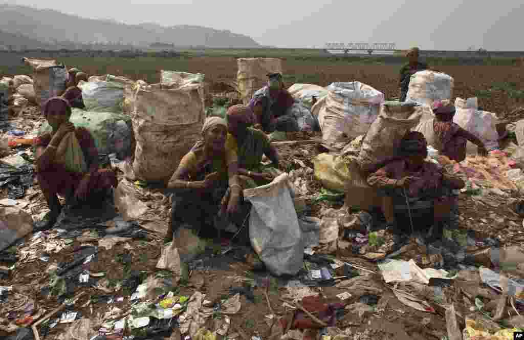 Indian ragpicker women rest after searching for recyclable material at a garbage dumping site on International Women&#39;s Day in Gauhati, March 8, 2017.