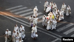 FILE - Nuns from the Jain community cross a road in Ahmedabad, India, Nov. 23, 2016.