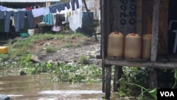 In Niger Delta cities like Warri fuel is sold in jerry cans from illegal refineires and often resold several times before it is used. (VOA/H. Murdock)