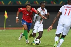 Gambia's defender Ibou Touray (L) is challenged by Mauritania's forward Idrissa Thiam during the Group F Africa Cup of Nations 2021 football match between Mauritania and Gambia at Limbe Omnisport Stadium in Limbe on Jan. 12, 2022.