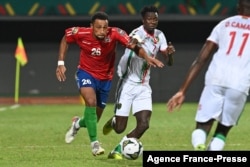 Gambia's defender Ibou Touray (L) is challenged by Mauritania's forward Idrissa Thiam during the Group F Africa Cup of Nations 2021 football match between Mauritania and Gambia at Limbe Omnisport Stadium in Limbe on Jan. 12, 2022.